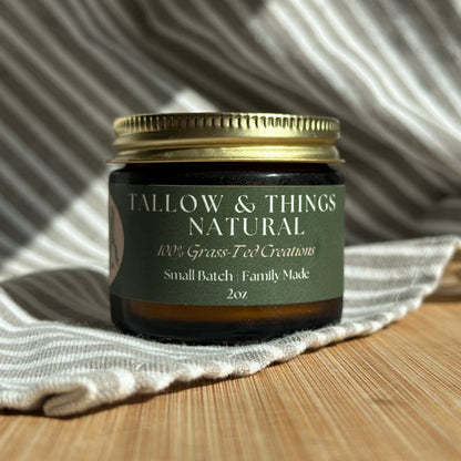 A jar of Naked tallow face moisturizer on a wooden surface with a white and striped fabric backdrop.